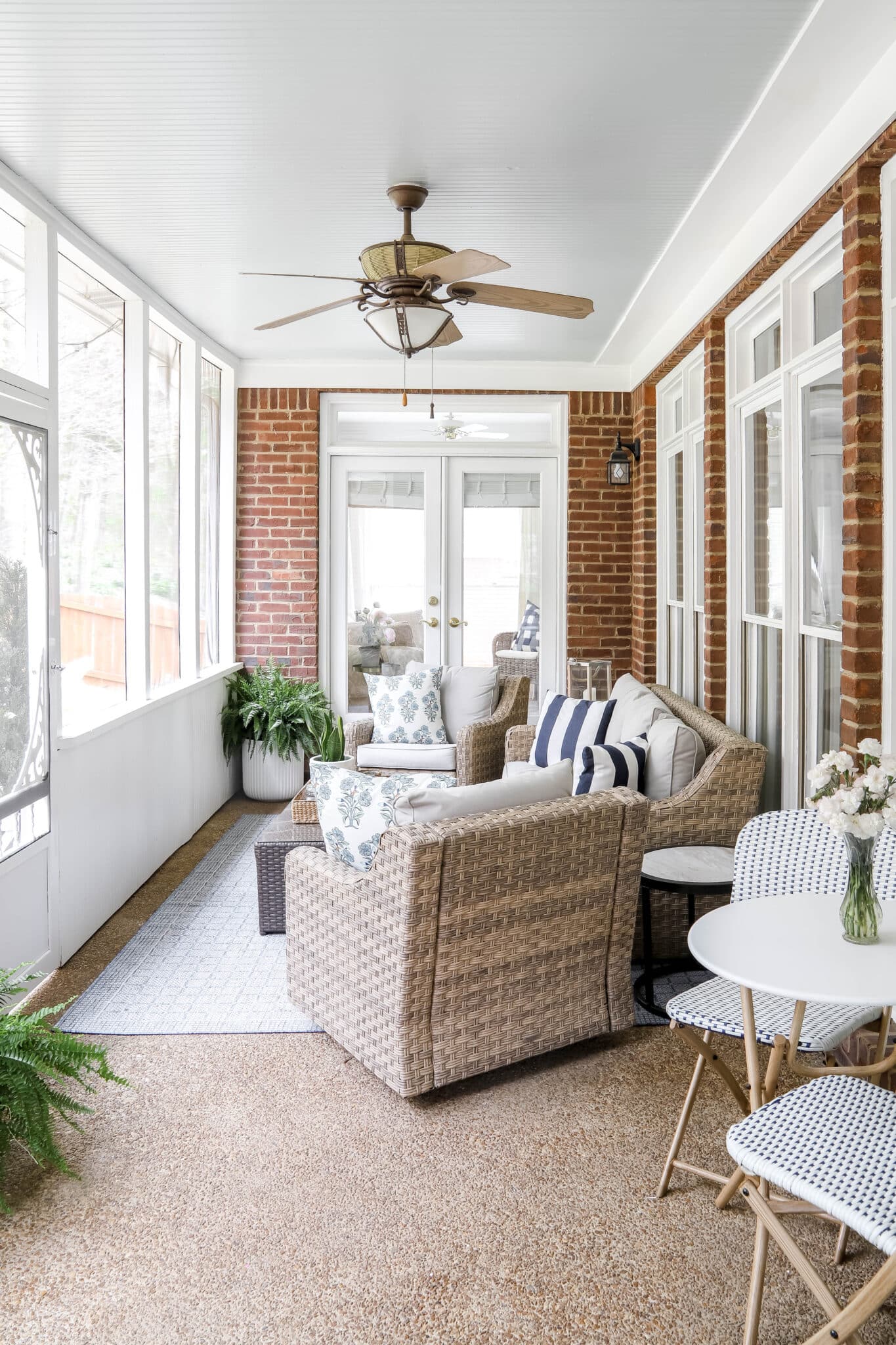 screened-in back porch with wicker furniture