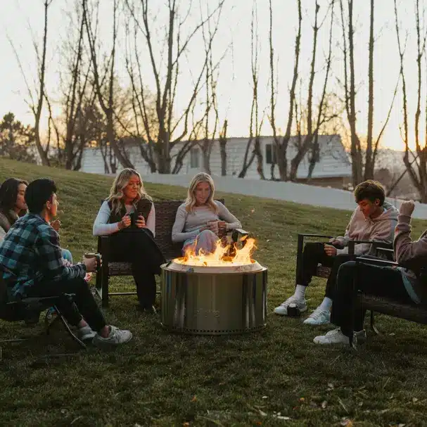 friends sitting around a Solo Stove fire pit
