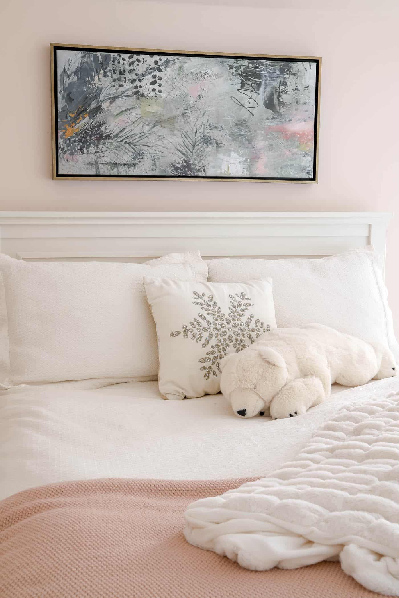 abstract plant art above bed.