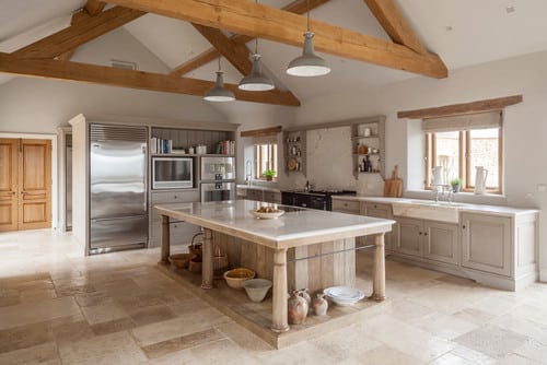 rustic kitchen with a scullery behind the fridge.