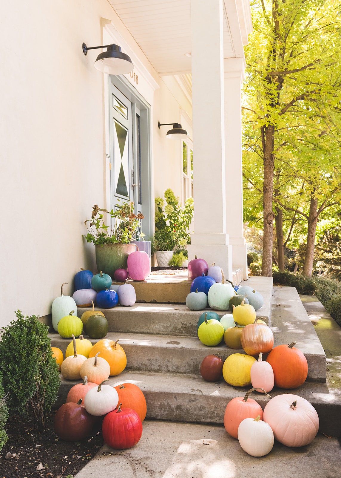 colorful modern pumpkins on front porch
