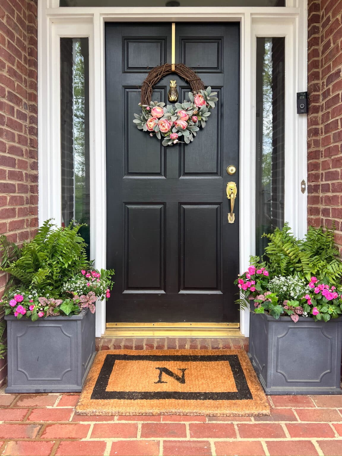 Planters with spring flowers on small front porch