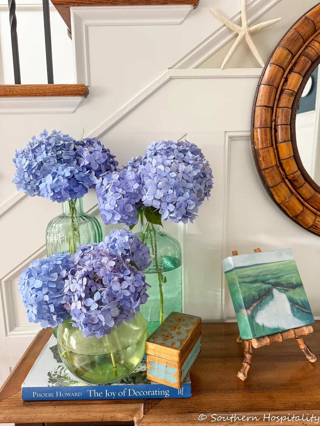beautiful blue hydrangeas inside in vases on a table.