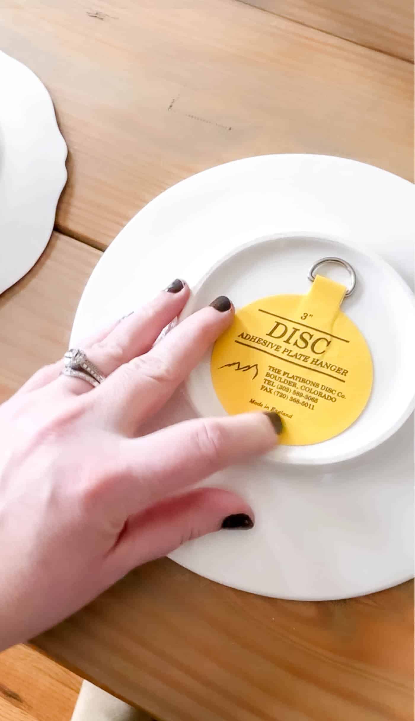 press on the back of the adhesive plate hanger to make sure it's well adhered.