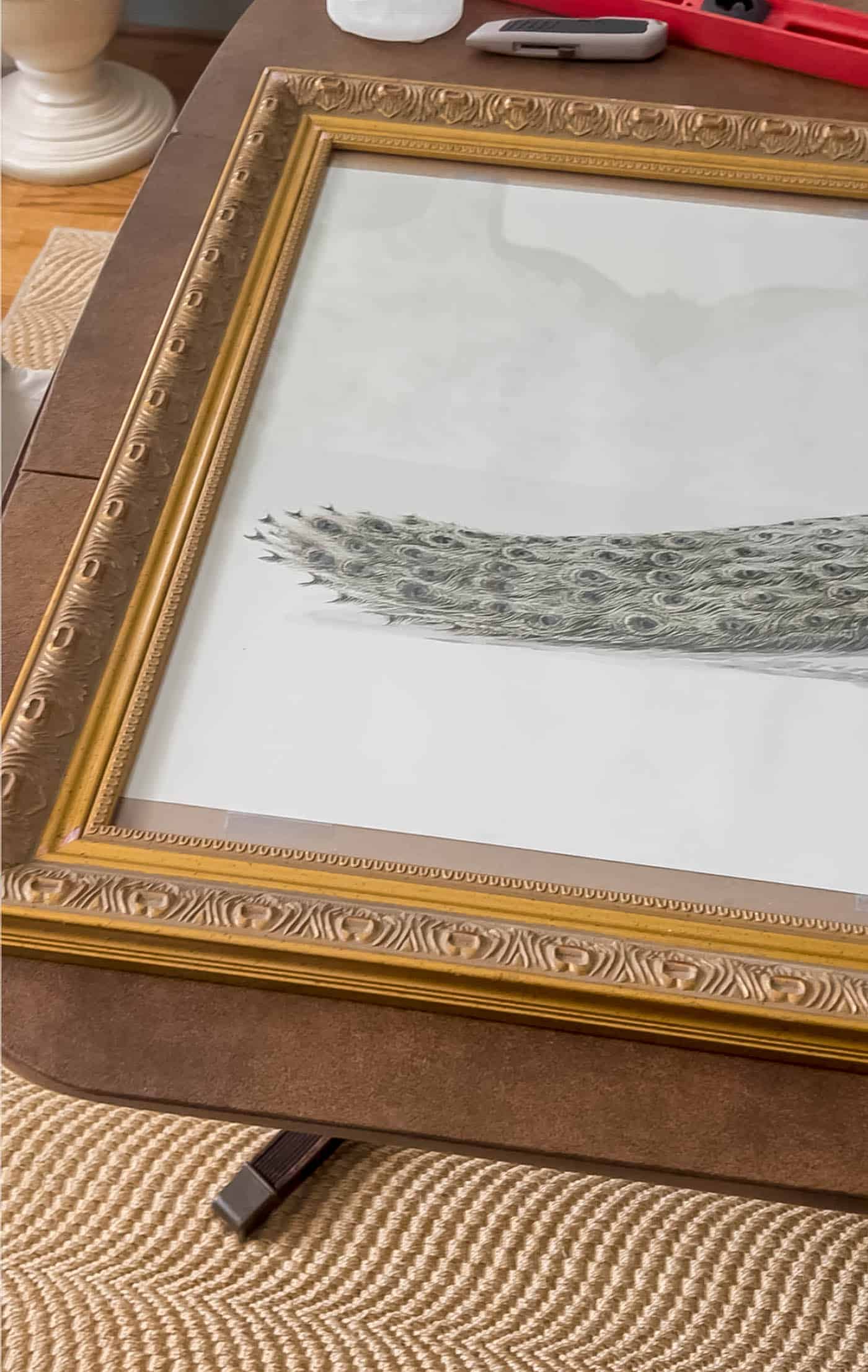 peacock art too small for the frame.