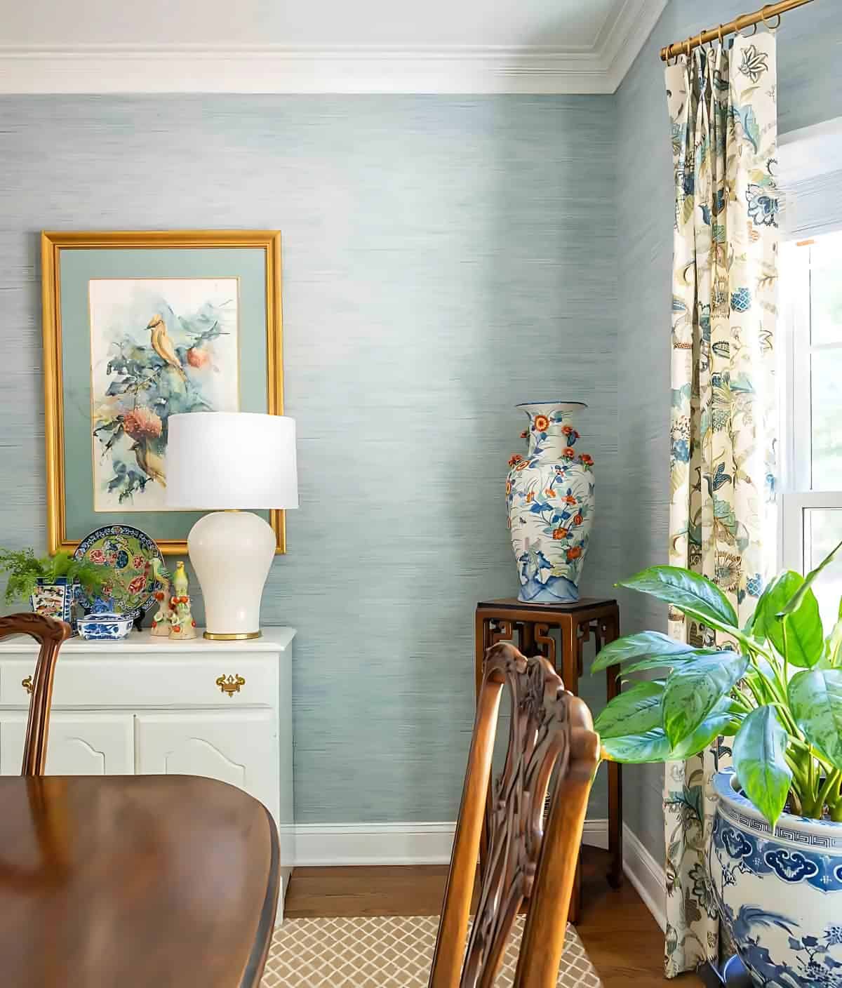 blue grasscloth wallpaper in a traditional dining room