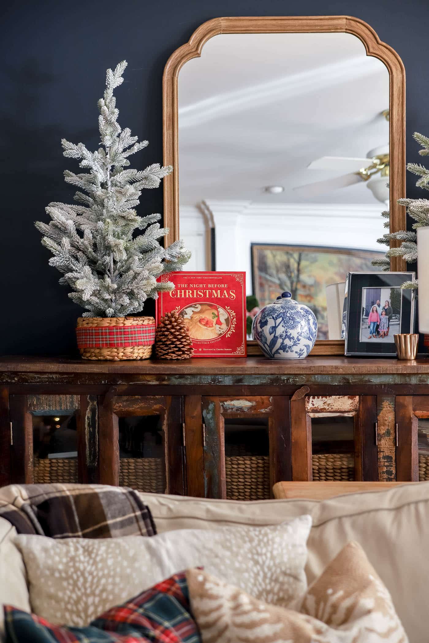The night before Christmas leather bound book on a shelf with blue and white chinoiserie pot and a faux potted flock christmas tree.