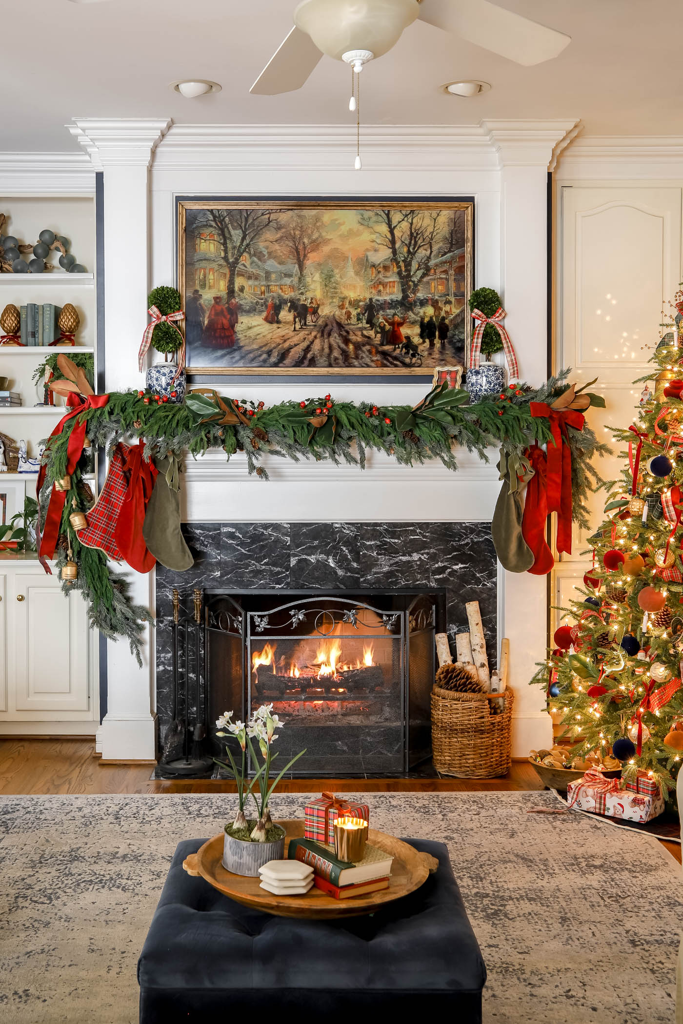 classic living room with mantel garland and Frame TV over the mantel.