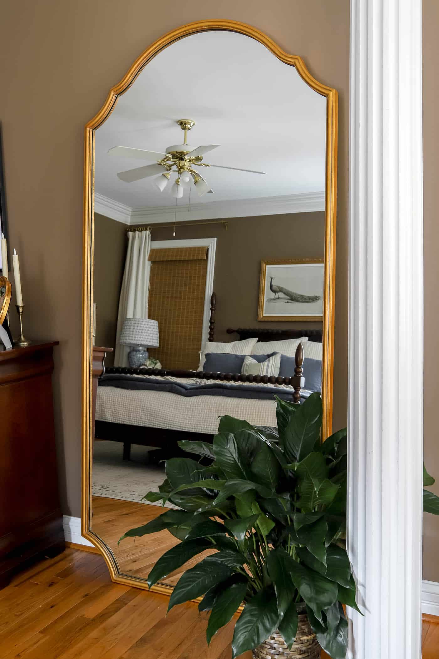 large leaning floor mirror in the bedroom.