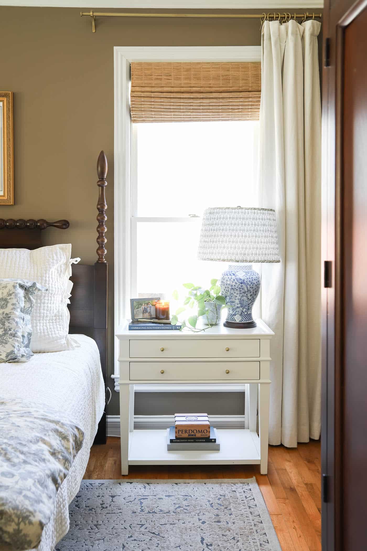 bedside table with lamp, cigar box and candle.