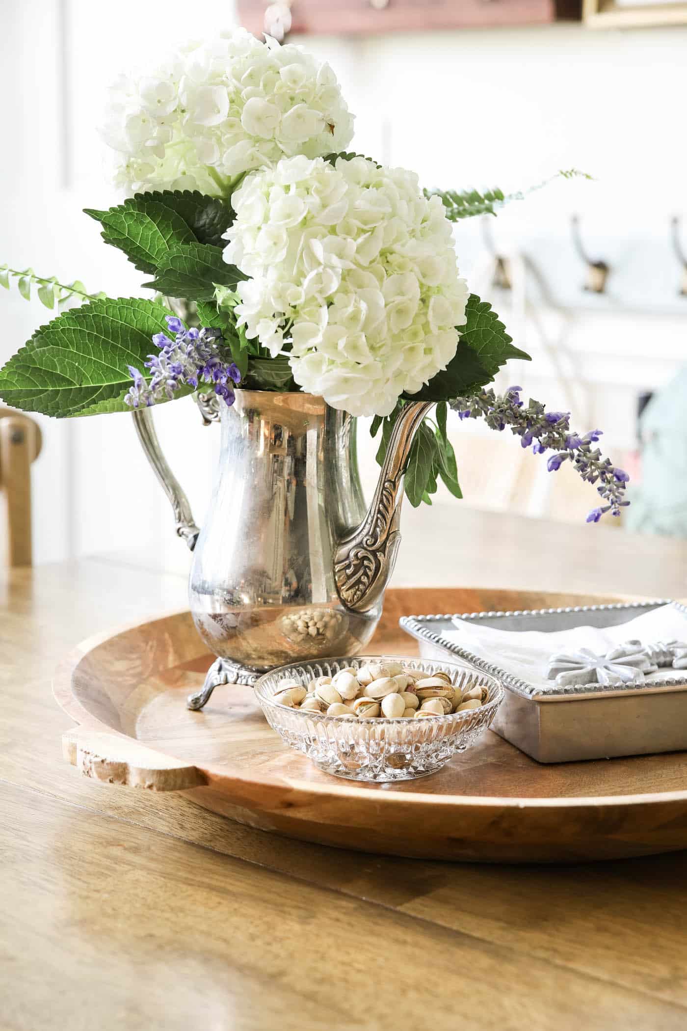 decorating with antique silver coffee pot as a vase.