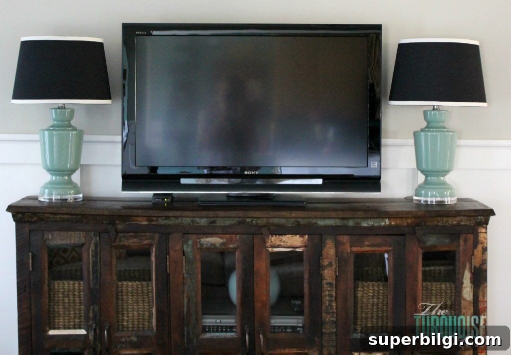 Living Room Makeover Part 4: Styling Blue Accents 3 blue glass lamps on media console