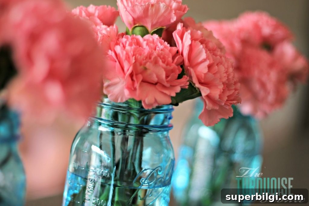 Living Room Makeover Part 4: Styling Blue Accents 7 Pink carnations in blue mason jars