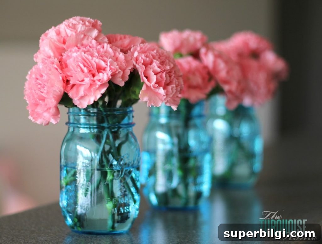 Living Room Makeover Part 4: Styling Blue Accents 9 Pink carnations in blue mason jars