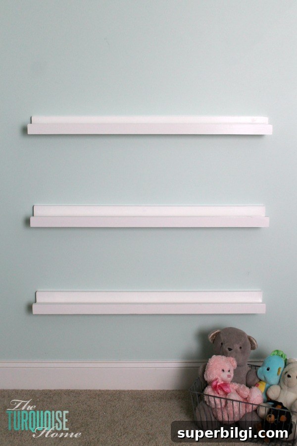 DIY Floating Bookshelf Ledges for Nursery Decor 10 Bookshelf ledge with books used as spacer during installation.