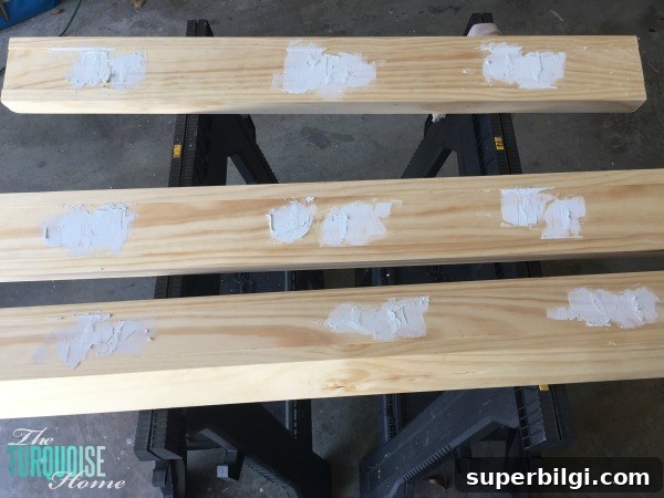 DIY Floating Bookshelf Ledges for Nursery Decor 7 Filling screw holes and sanding ledges smooth.