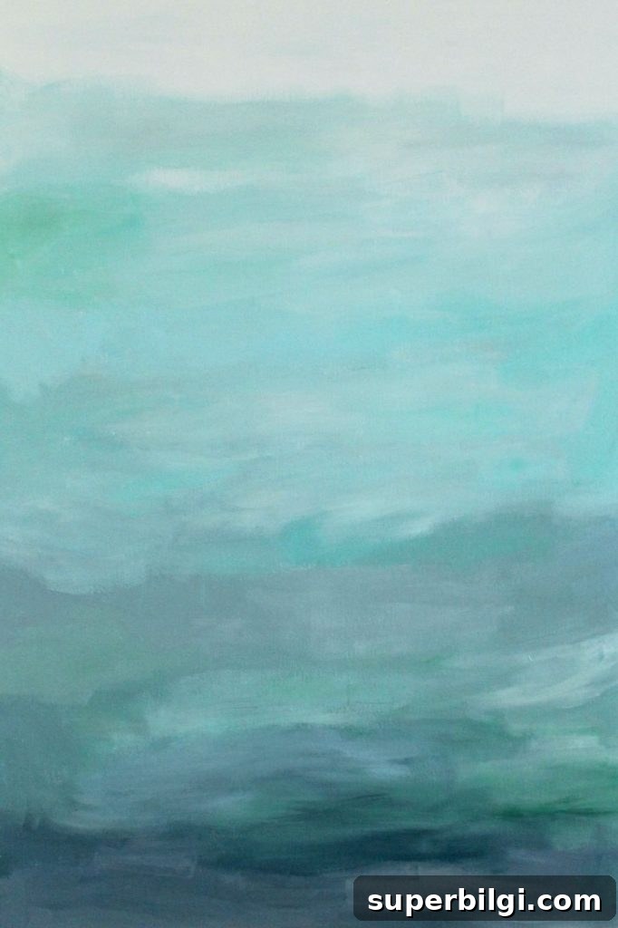 Gorgeous blue waters have the makings of an expensive abstract art piece, but it's not! It's a quick DIY project with just paint and a canvas! Less than $25 for custom, gorgeous art in your home.