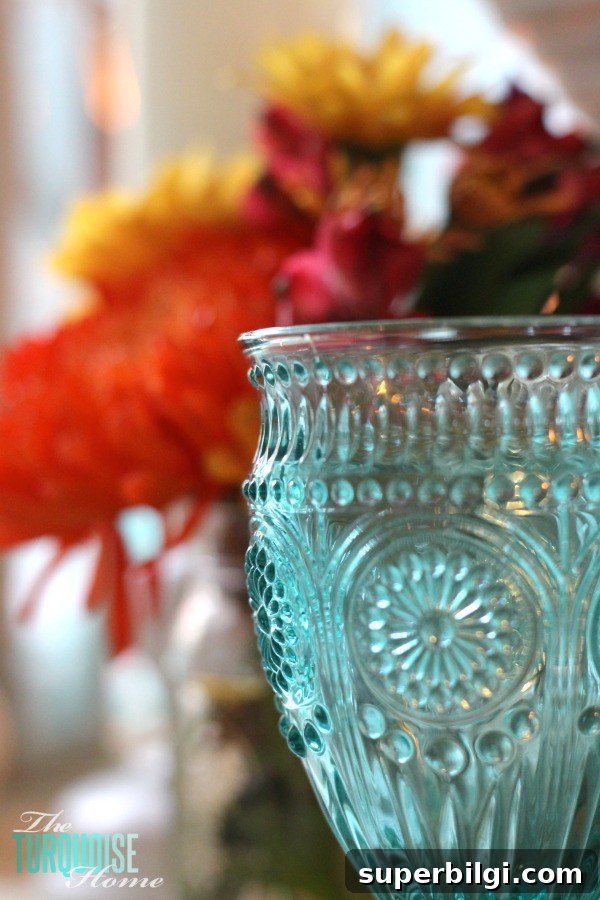 Turquoise Thanksgiving Tablescape Ideas for a Chic Holiday Table 5 Gorgeous! This pretty, colorful fall or Thanksgiving tablescape is just beautiful with pops of turquoise, orange and red! And those beautiful goblets are my fave!