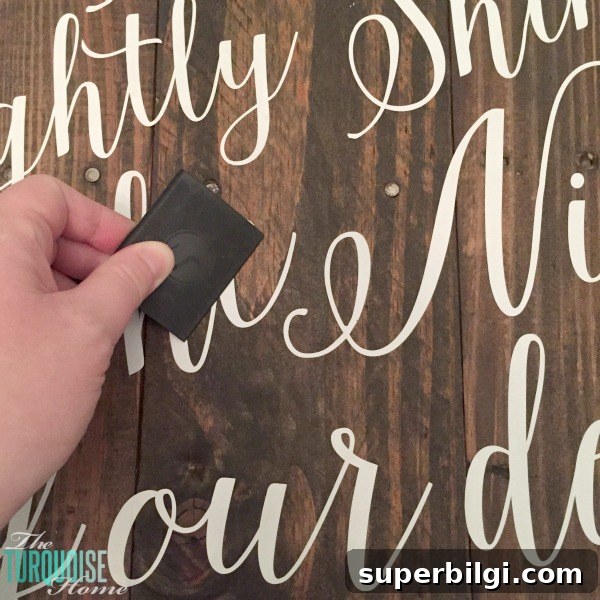 Personalize your Christmas decor with a DIY lettered pallet sign! Full tutorial at TheTurquoiseHome.com