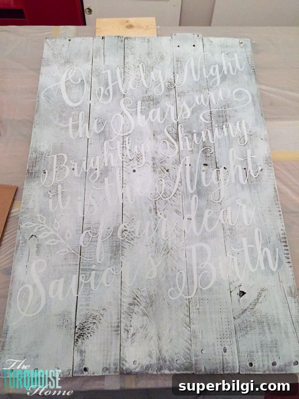 Personalize your Christmas decor with a DIY lettered pallet sign! Full tutorial at TheTurquoiseHome.com
