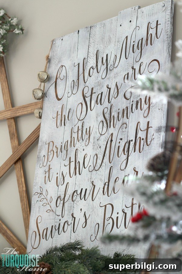Personalize your Christmas decor with a DIY lettered pallet sign! Full tutorial at TheTurquoiseHome.com