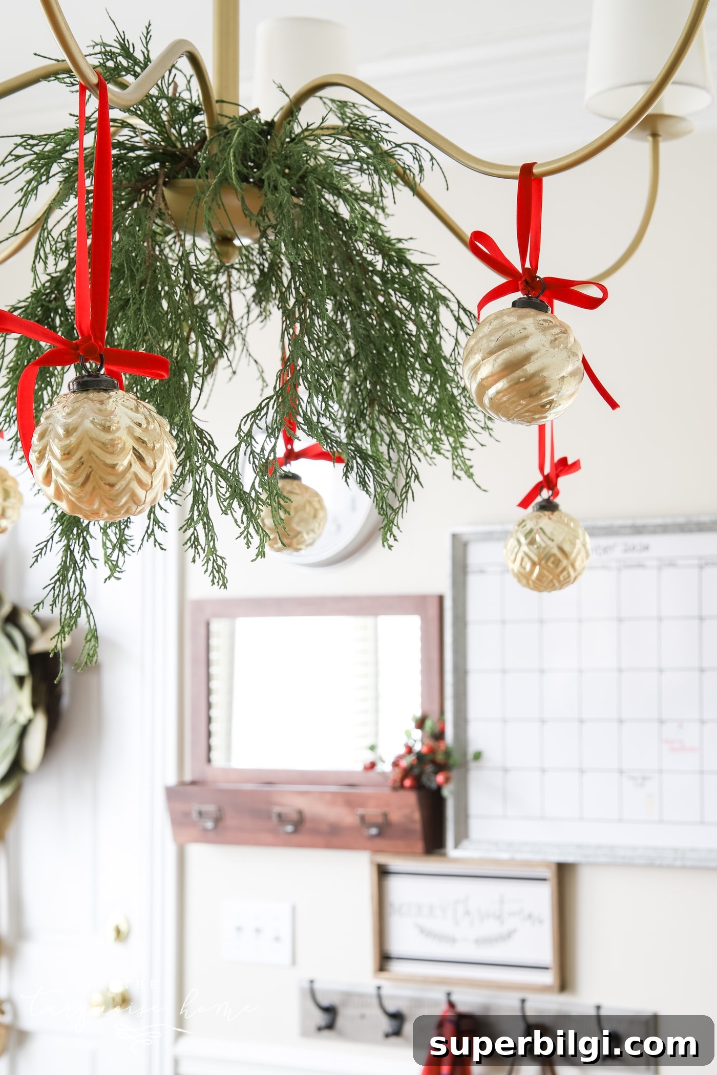 Affordable DIY Christmas Decor Ideas 8 Greenery on Chandelier for Christmas