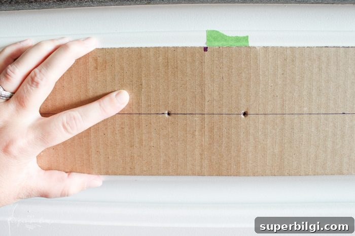 How to Measure and Install Cabinet Pulls for Perfect Alignment 3 Cardboard template aligned to drawer for marking pull holes