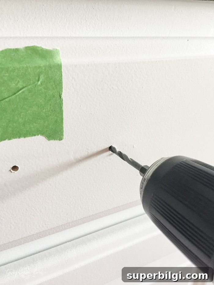 How to Measure and Install Cabinet Pulls for Perfect Alignment 5 Drilling through marked holes for cabinet pulls