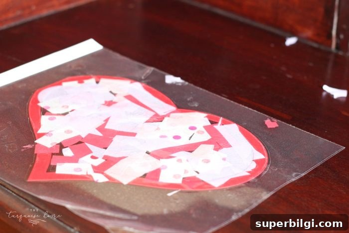 Tissue pieces placed on the sticky laminating sheet inside the heart outline