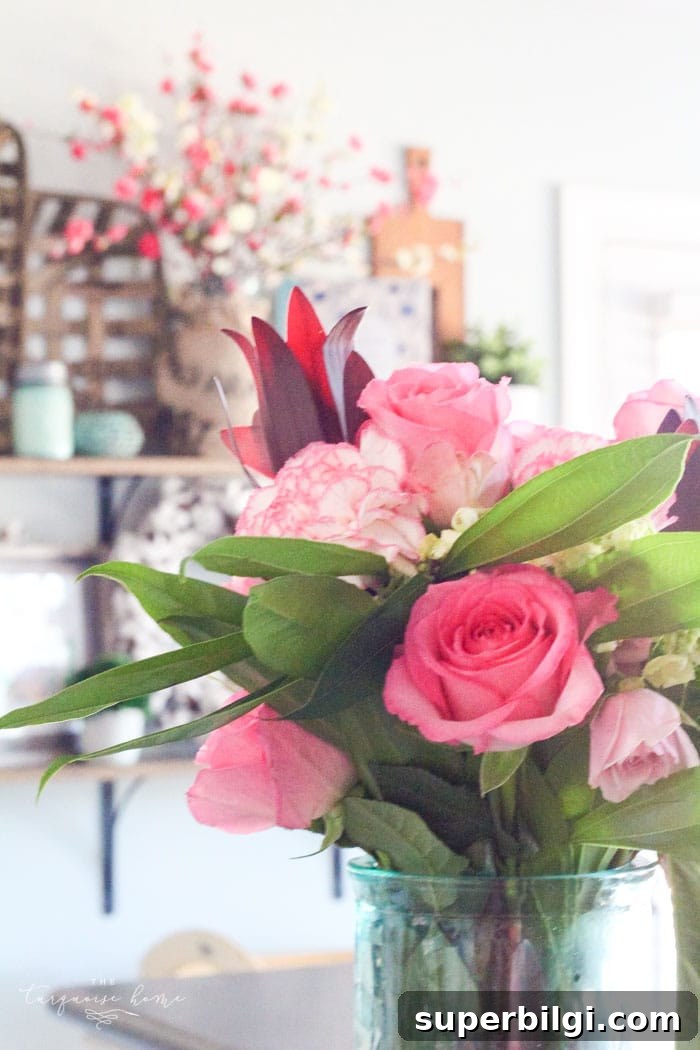 Isn't this just the prettiest pink and turquoise mantel?! Simple Floral Spring Mantel