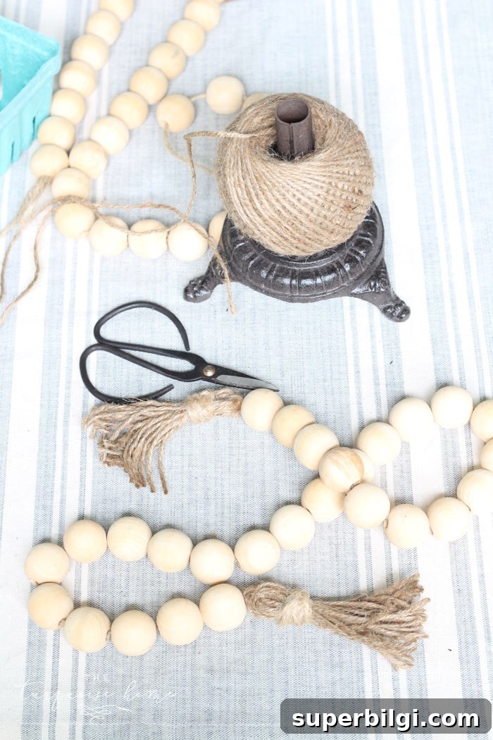 Super cute DIY Wood Bead Garland with Tassels is so easy and fun to make! Cheap, too!!