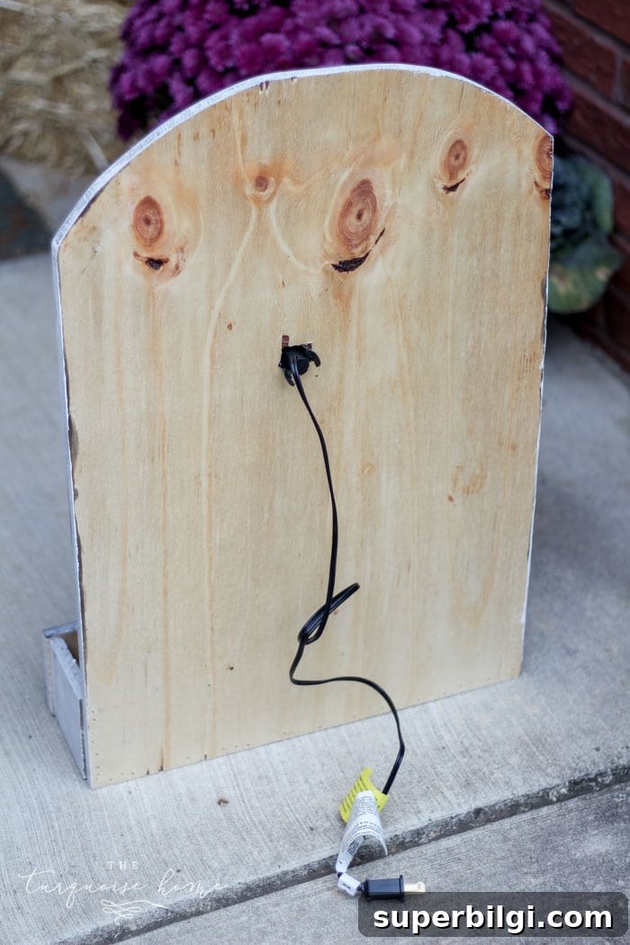 DIY Lighted Pumpkin Candy Holder: Halloween Decor 14 Attach the light to the hole in the back of the board for your lighted pumpkin candy holder! Plug it in and voila - the cutest jack-o-lantern candy holder you've ever seen!