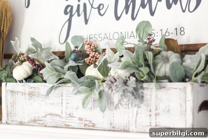 Create a Stunning Faux Foliage Table Centerpiece 3 Adorable faux foliage centerpiece made with a wooden box, mason jars and faux stems