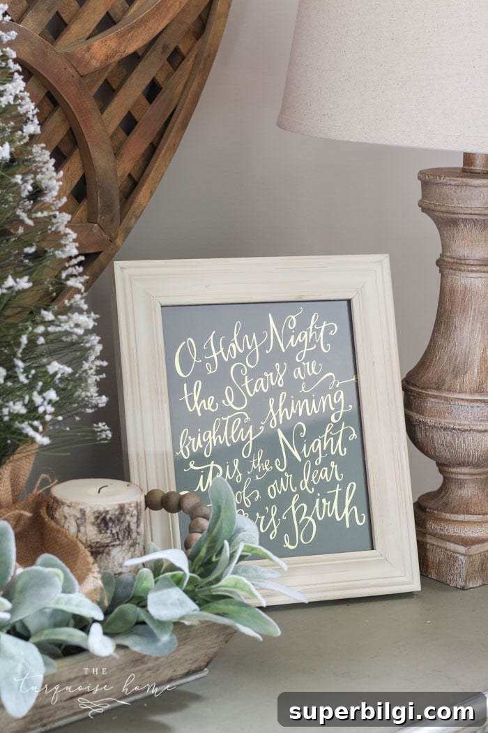 Neutral Christmas Entryway Ideas for a Warm Welcome 9 O Holy Night art adds just enough holiday decor to this space! A neutral Christmas entry way - not too fussy or fancy!