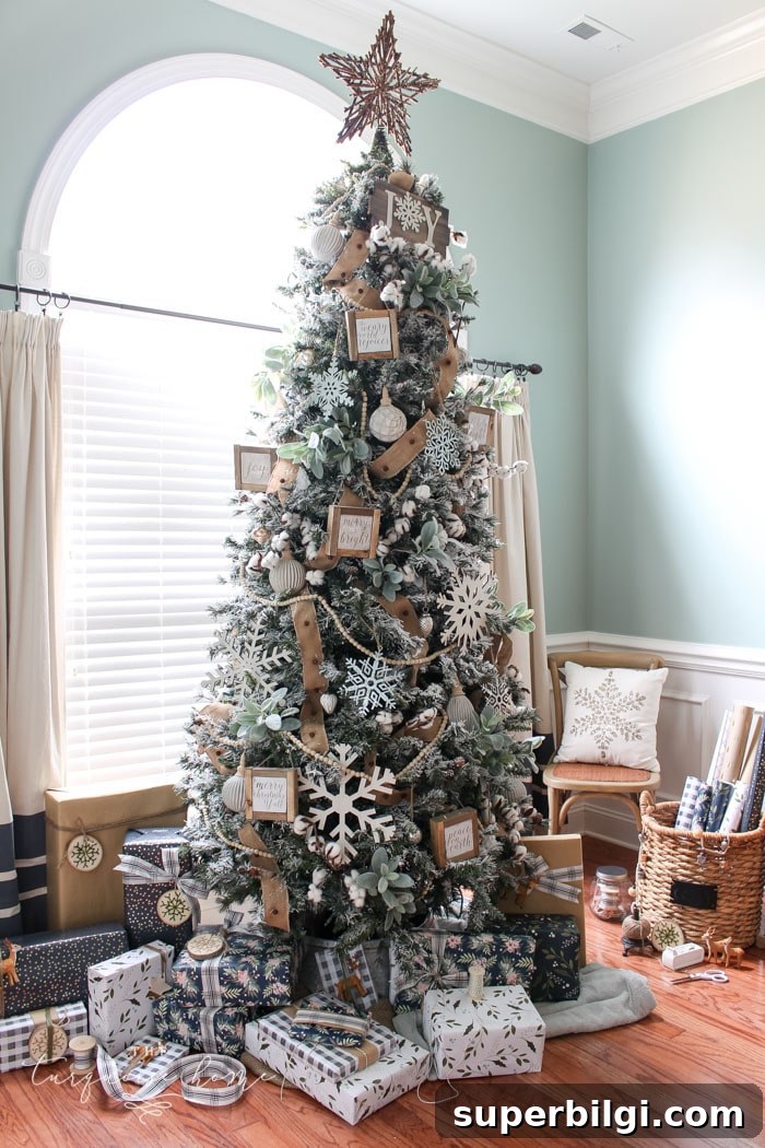 My Flocked Farmhouse Christmas Tree - super cute cotton stems, lamb's ear, galvanized snowflakes, and wooden bead garland.