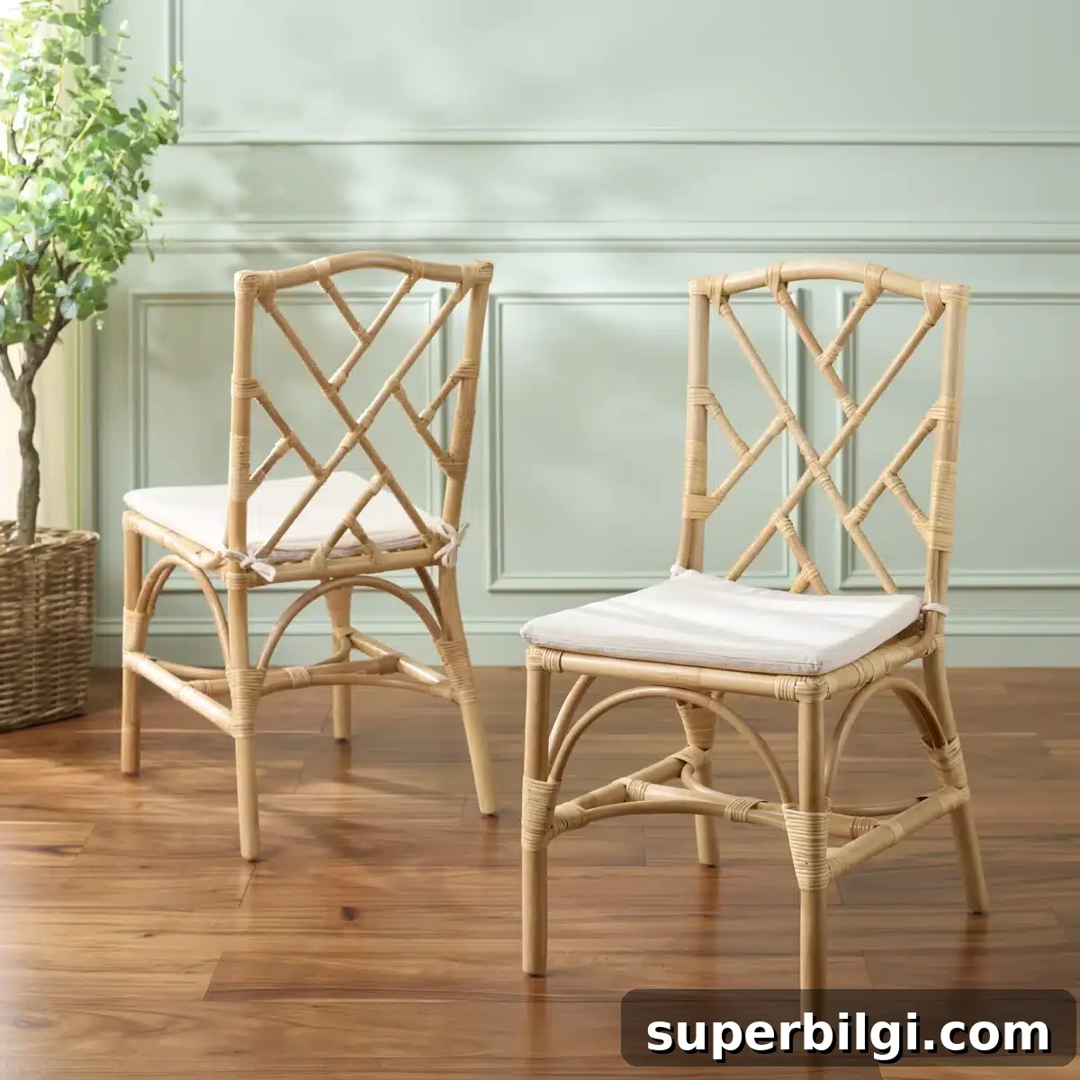 26+ Affordable Dining Chairs for Every Style (2026 Guide) 4 Natural woven rattan dining chairs with removable white cushions in a coastal dining room style.