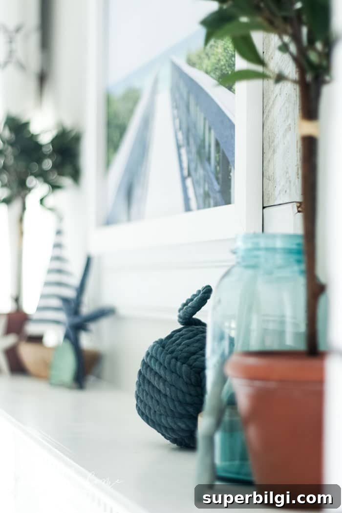 Coastal Summer Mantel Decor Ideas to Refresh Your Space 2 Add a little nautical charm to your living space with these simple coastal summer mantel decor ideas. Featuring DIY beach canvas art, blue & white starfish, textured sailor's knot and cheerfully striped sail boats, this mantel looks great for the seasonally inspired.