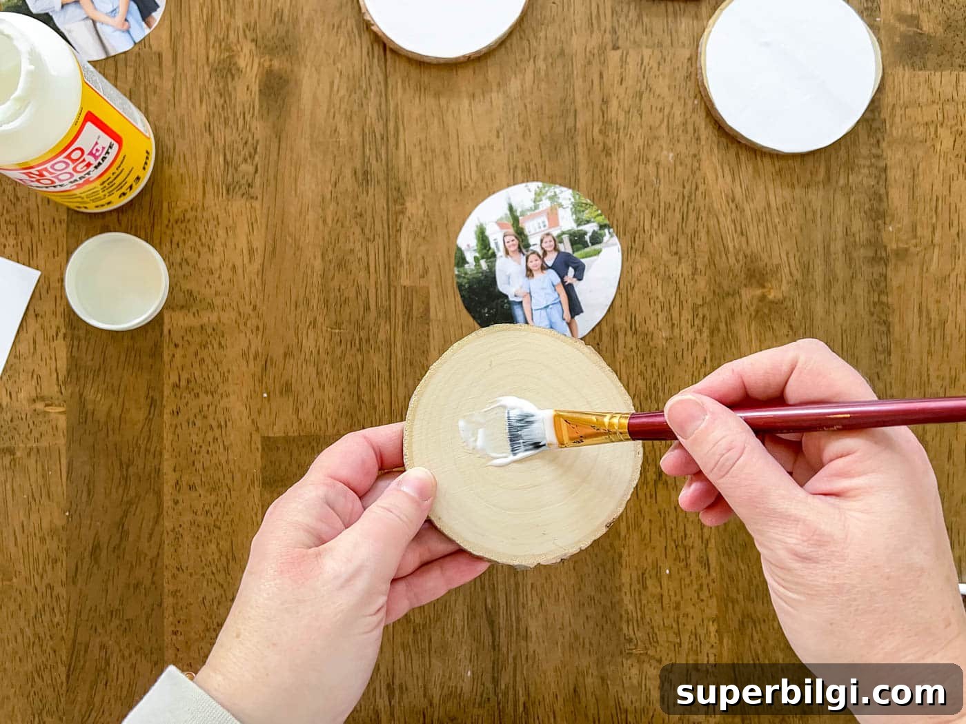 DIY Photo Transfer to Wood: Step-by-Step Guide 5 paint a layer of Mod Podge on the wood slice