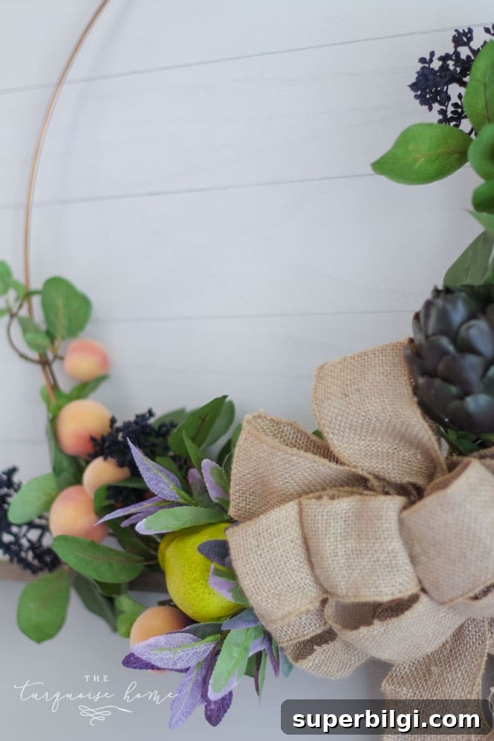 Autumn Hoop Wreath with Fruit Accents and Shiplap Frame 10 Add a burlap bow to the center of the hoop wreath to cover up all of the stems and floral wire in the middle!