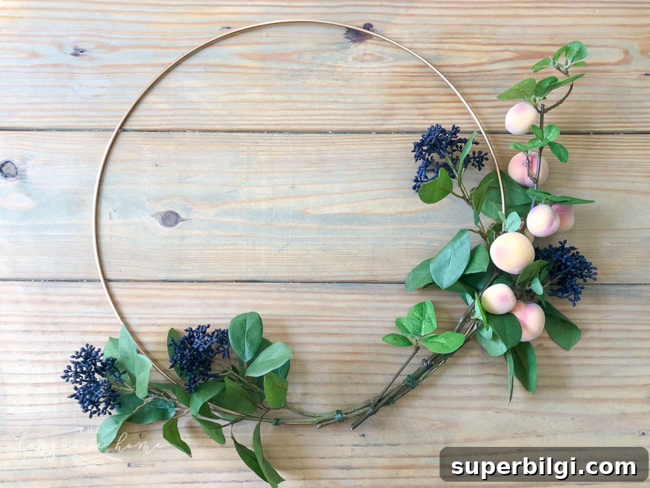 Autumn Hoop Wreath with Fruit Accents and Shiplap Frame 8 Attach the floral and fruit stems to the wreath hoop.