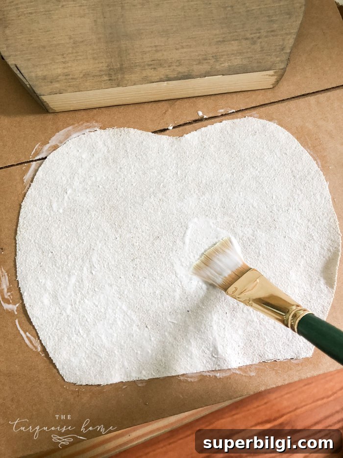 DIY Farmhouse Wooden Pumpkin for Fall Decor 6 Use Mod Podge to glue the drop cloth to the pumpkin.