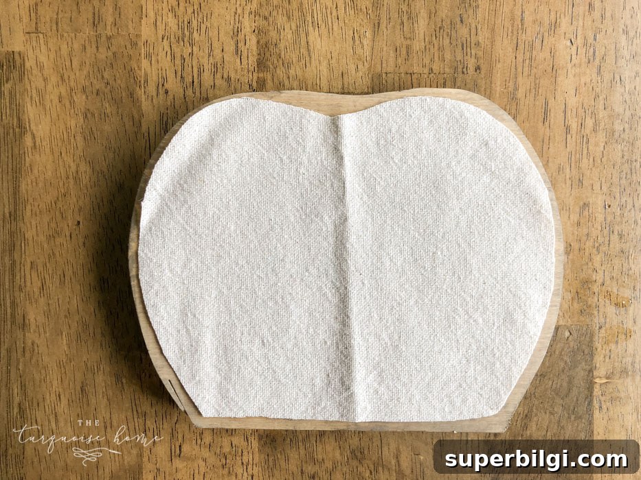 DIY Farmhouse Wooden Pumpkin for Fall Decor 7 Use Mod Podge to glue the drop cloth to the pumpkin.