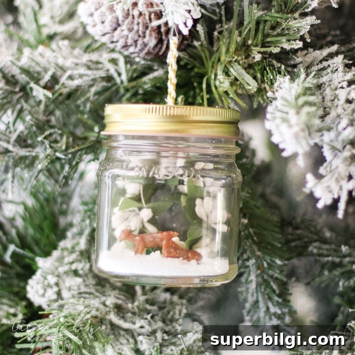 How to Make a Mason Jar Snow Globe Ornament for Christmas 4 DIY Mason Jar Snow Globe Ornaments with mini deer and winter wreath