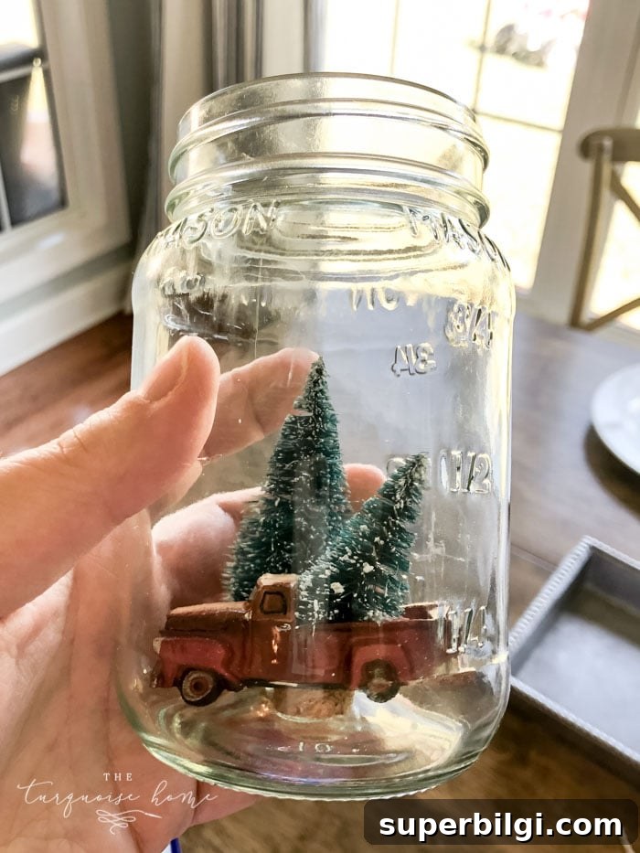 How to Make a Mason Jar Snow Globe Ornament for Christmas 7 Miniatures arranged and glued inside lid
