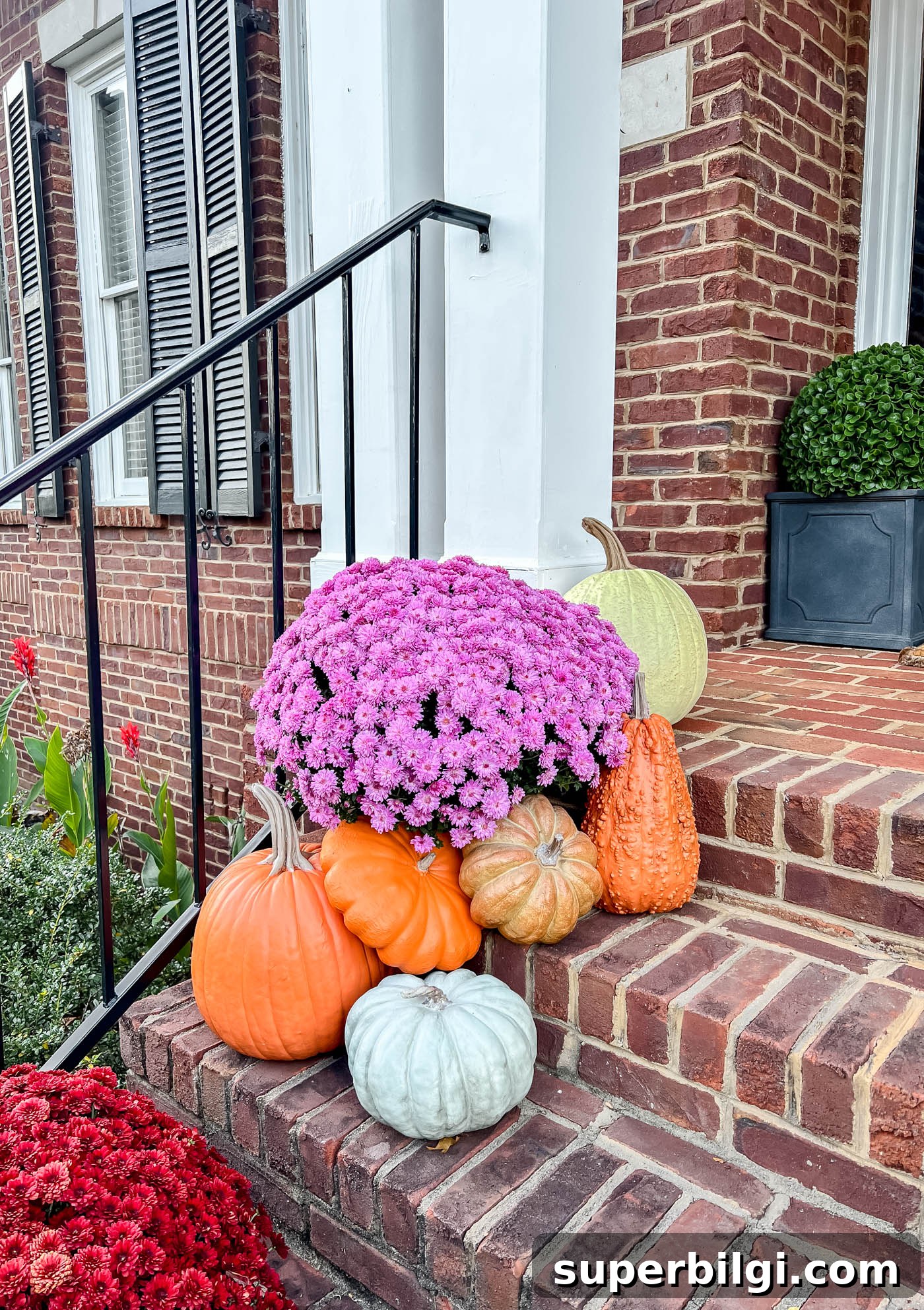 Affordable Fall Decor Ideas for a Cozy Home 14 Realistic fake pumpkins on front porch steps.