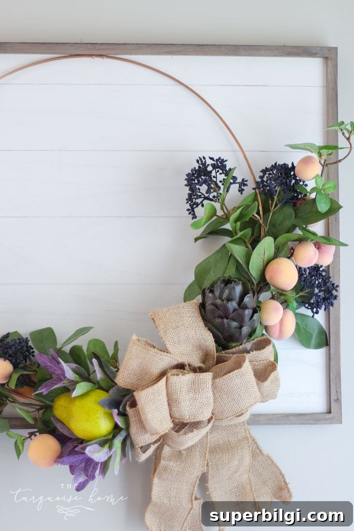 Affordable Fall Decor Ideas for a Cozy Home 7 Gorgeous fall wreath with fruit on a "shiplap" framed backdrop.