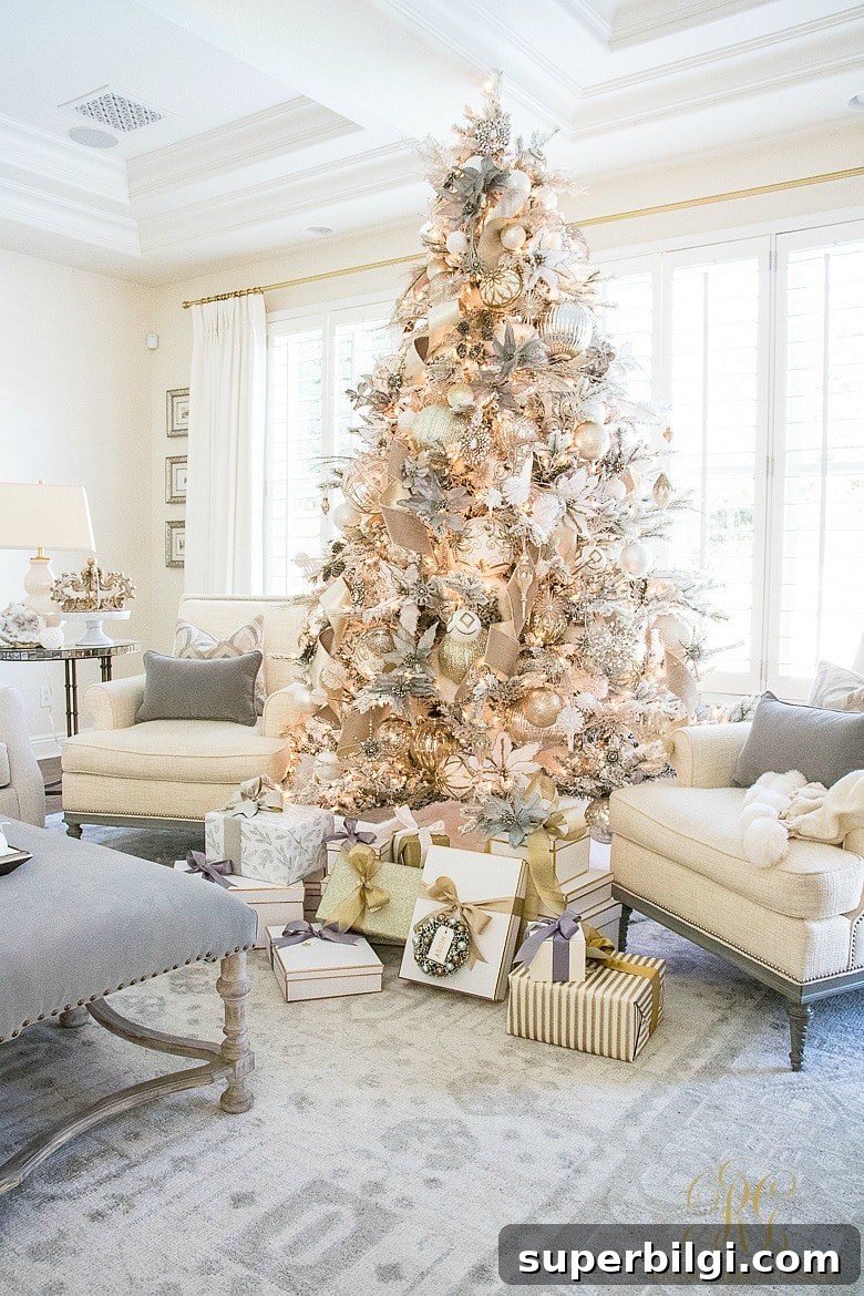 Stunning Flocked Christmas Tree Ideas for a Snowy Look 13 ornately decorated flocked Christmas tree with sitting chairs and unopened gifts beneath it.