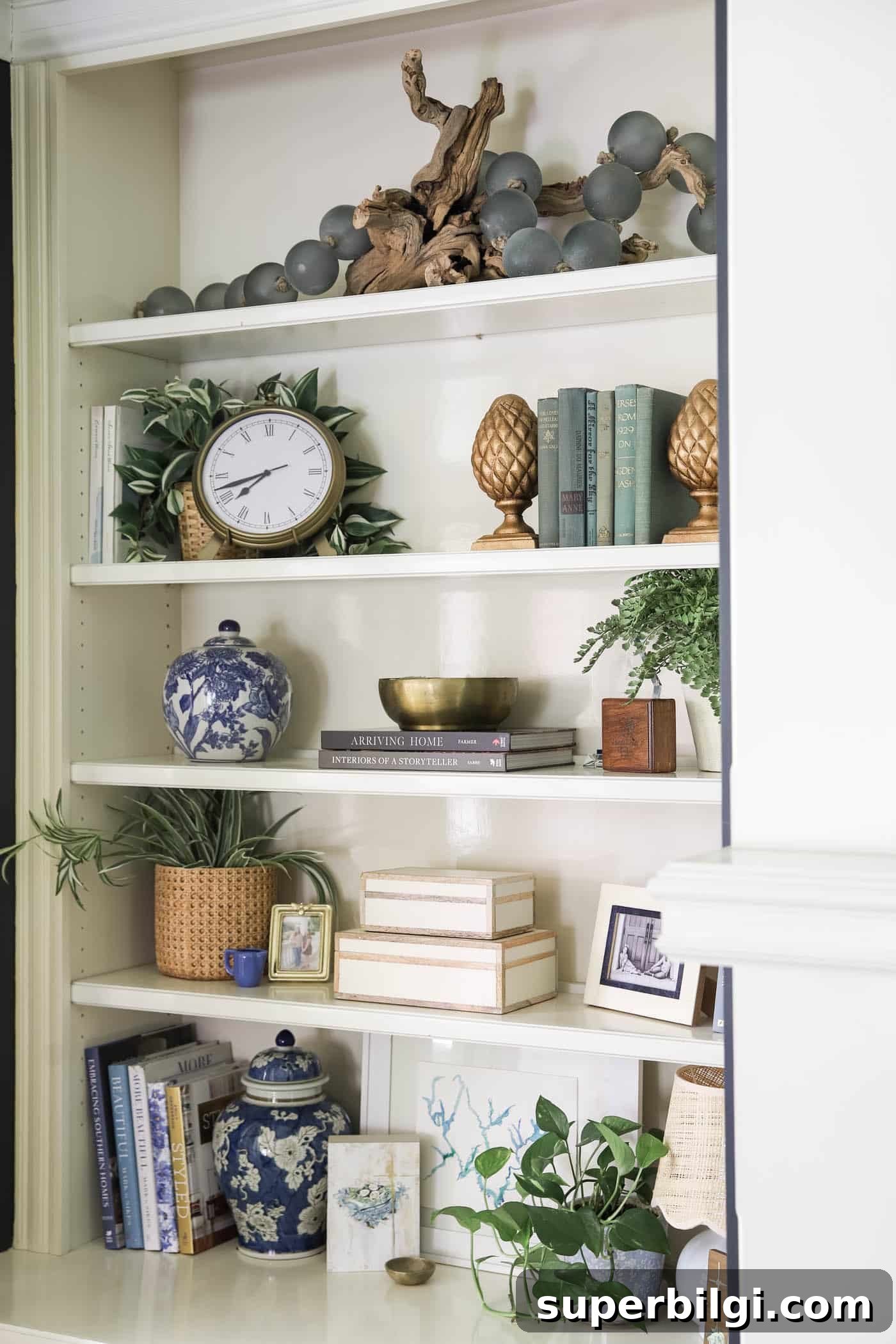 Bookshelf Styling Ideas to Transform Your Bookcase 10 layering art and decorative objects on a bookshelf.