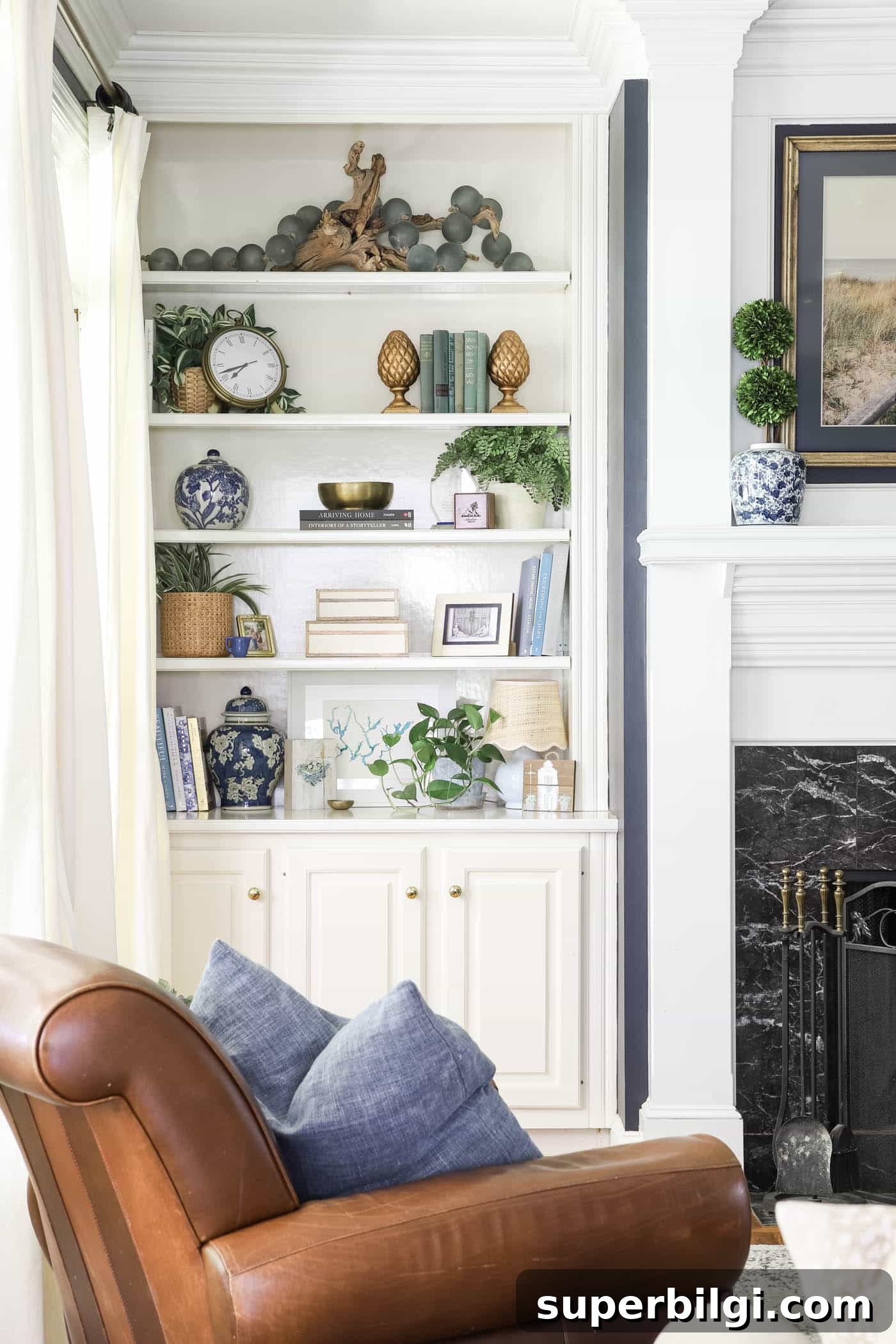 Bookshelf Styling Ideas to Transform Your Bookcase 5 summer built-in bookshelf decor in a white and blue living room.