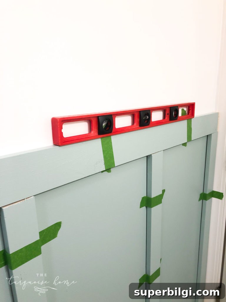 How to Install Board and Batten in a Girls' Bathroom 8 Make sure all boards are level